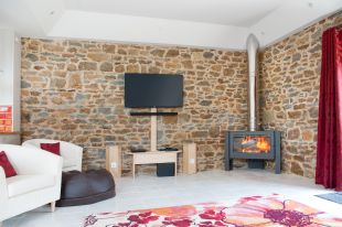 3 The comfortable lounge with large TV and wood burner for the colder weather 