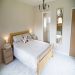 The master bedroom with king size bed, en suite shower room and views of the garden 