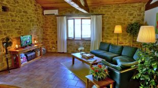 Woonkamer met Leolux hoekbank en flatscreen tv