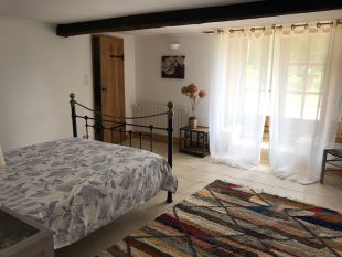 Master bedroom with view to the French doors and garden beyond